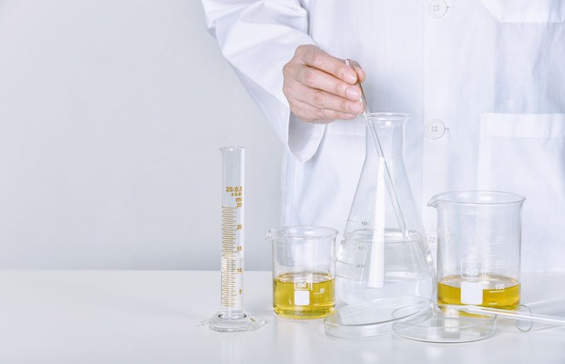 industrial flavor chemist formulating flavoring in lab