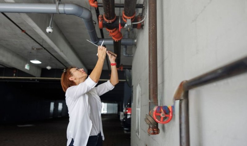 a woman inspecting leaks. emergency roofing