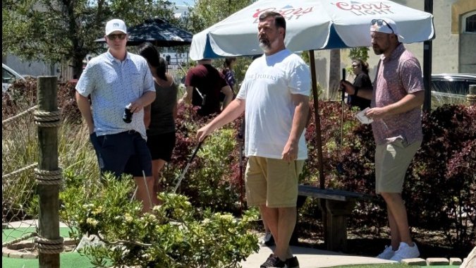 Community sports players at a mini golf course