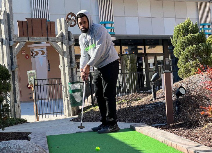 Sports fans competing in a mini golf league
