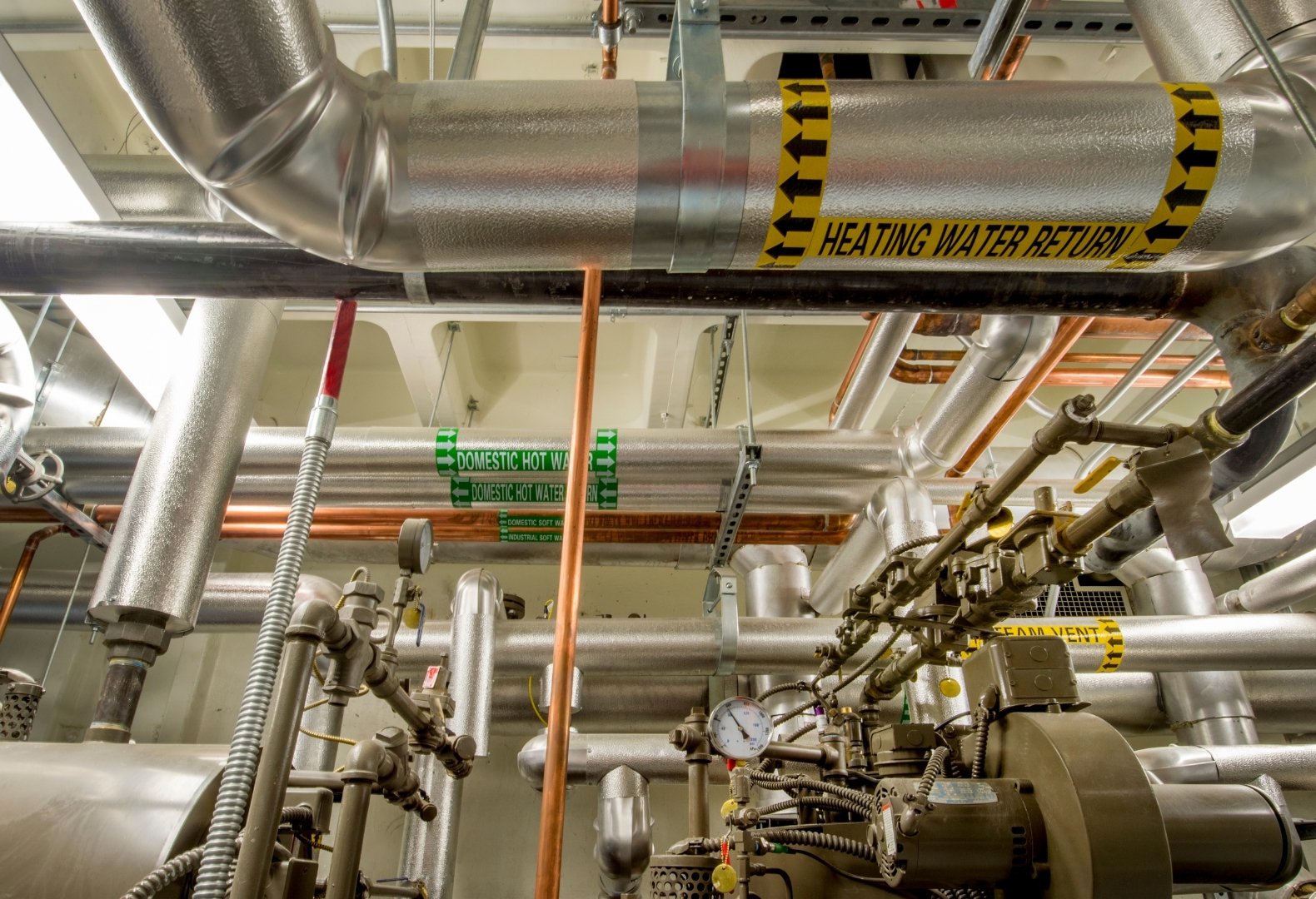 Boiler room pipes in a commercial building. Boiler room pipes in a commercial building.