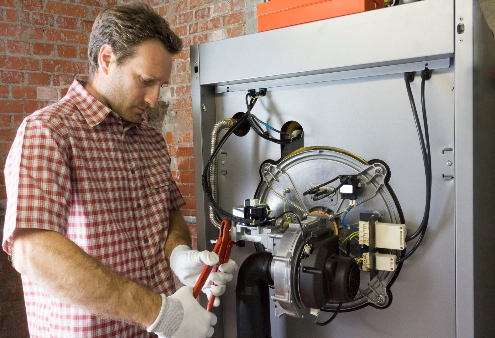 A plumber about to perform boiler room repairs. A plumber about to perform boiler room repairs.