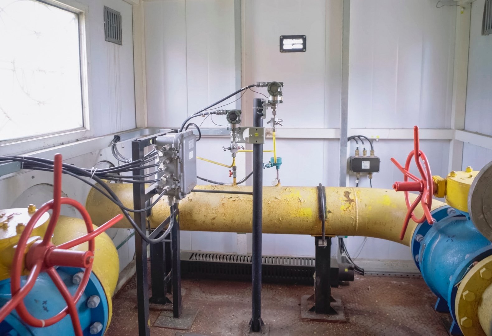 Old pipes in a boiler room in need of a boiler compliance check.