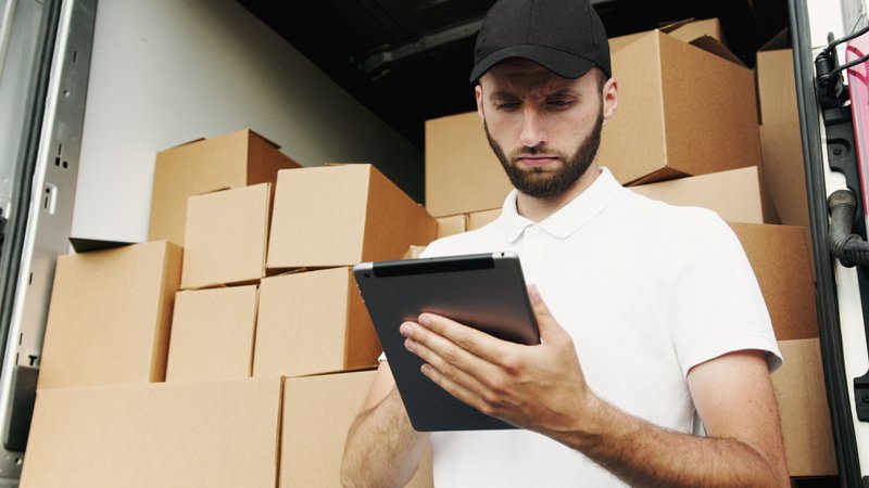 Delivery truck driver checking inventory details