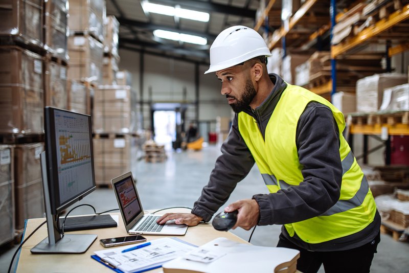 Warehouse employee checking freight compliance.