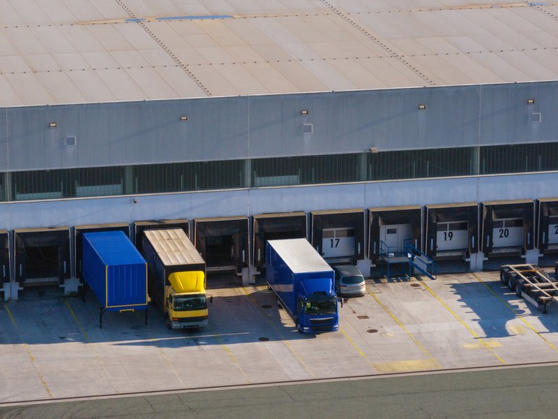 Freight audit, trucks about to leave a loading dock.
