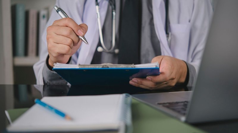 physician reviewing malpractice insurance consent to settle clause policy details