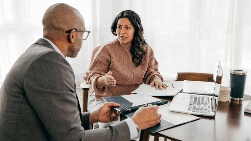 A dentist and an insurance advisor discussing coverage terms for Dentist Liability Insurance.