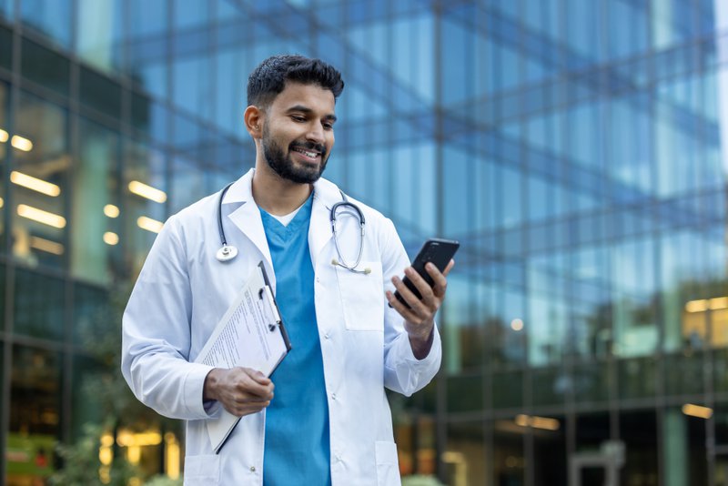 A physician checking something on his phone.