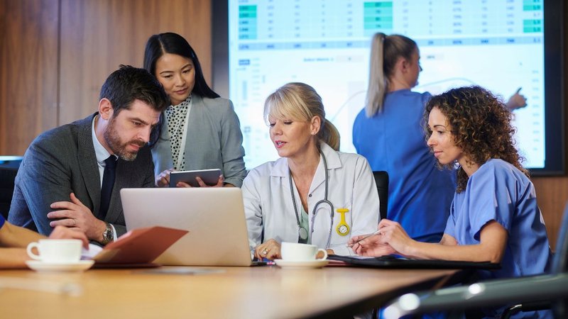 Doctor reviewing malpractice insurance documents while assessing coverage for the most sued medical specialties