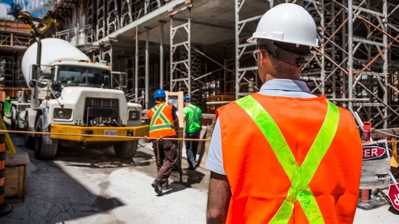 A construction worker at an active job site during a Data Center Site Selection Safety assessment.