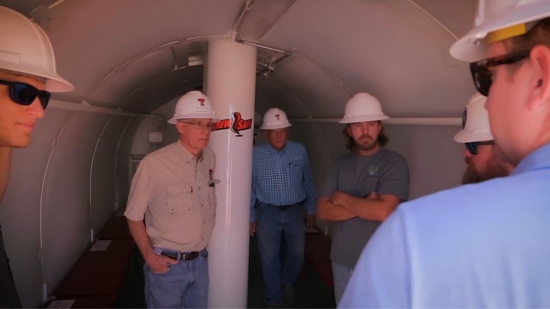 Group of workers testing a mobile unit from a certified storm shelter manufacturer.