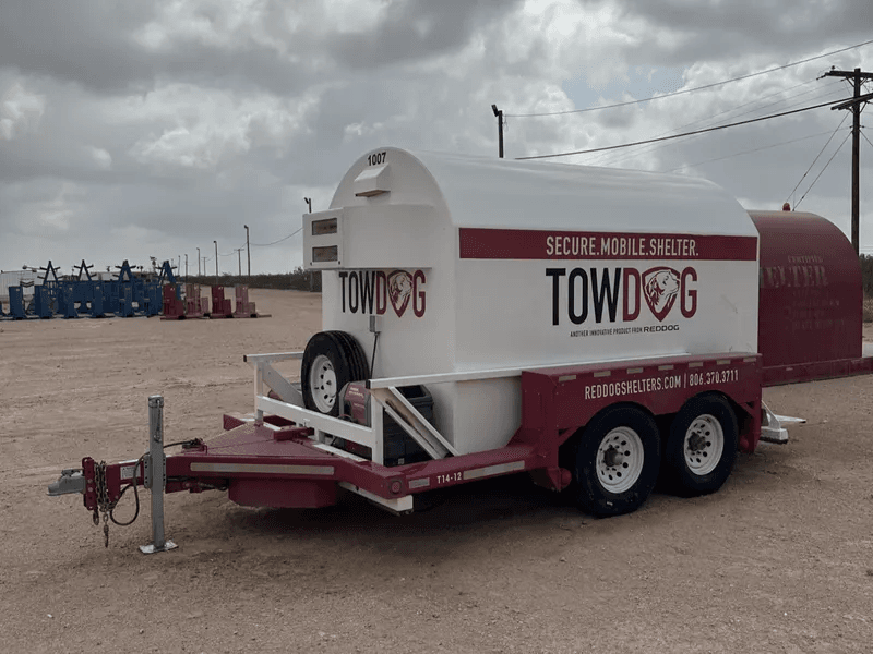 The cylindrical unit features the branding "SECURE. MOBILE. SHELTER." and includes an integrated generator and spare tire on the front hitch assembly.