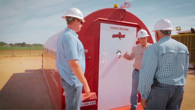 Crew members standing near a portable clean room designed for Remote Workforce Safety Solutions.