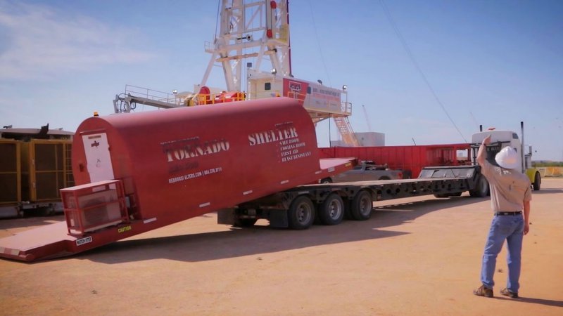 Workers moving a protective shelter on a flatbed trailer to support Data Center Resilience Strategies.