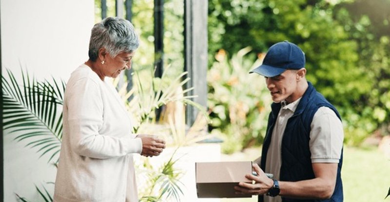 an elderly woman receiving a package