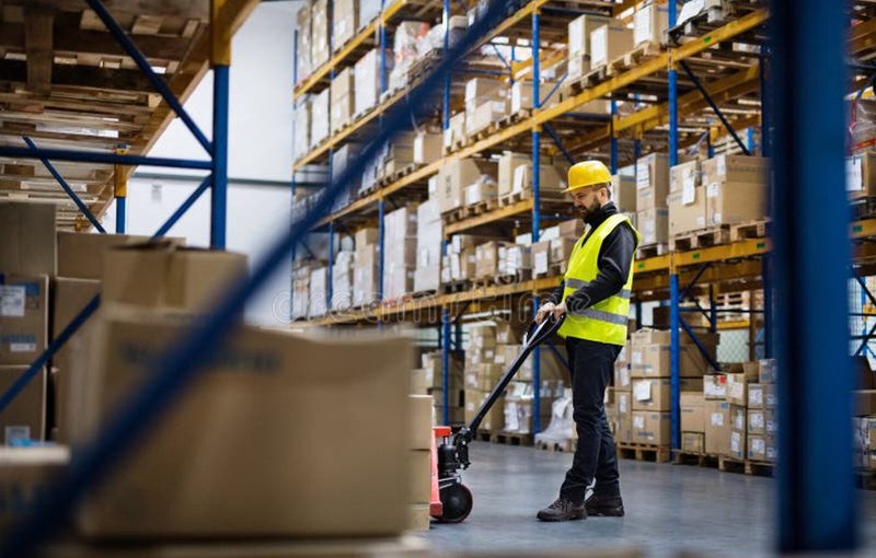 a worker carefully storing items