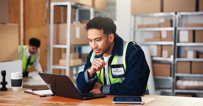 a worker looking at the inventory on his computer