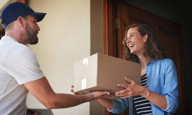 a worker handing over the package to the recipient
