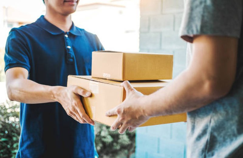 a worker handing over packages to the recipient