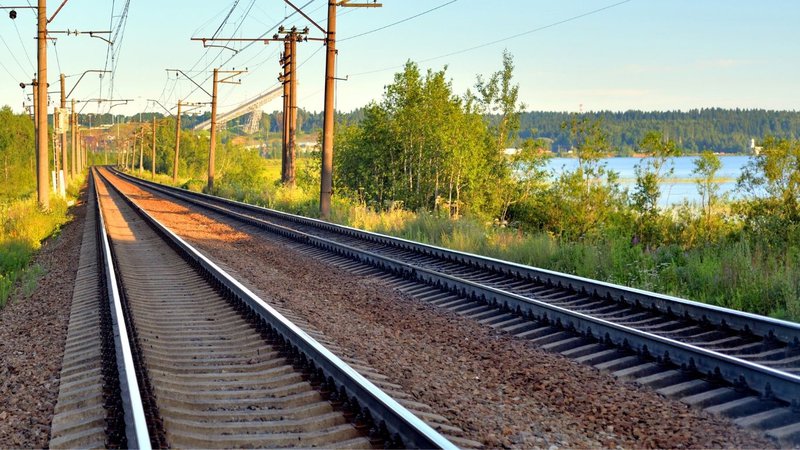 Parallel railroad tracks stretching into the distance for regional rail transloading.