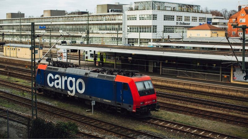 A cargo train transporting bulk manufacturing materials for industrial paper logistics.