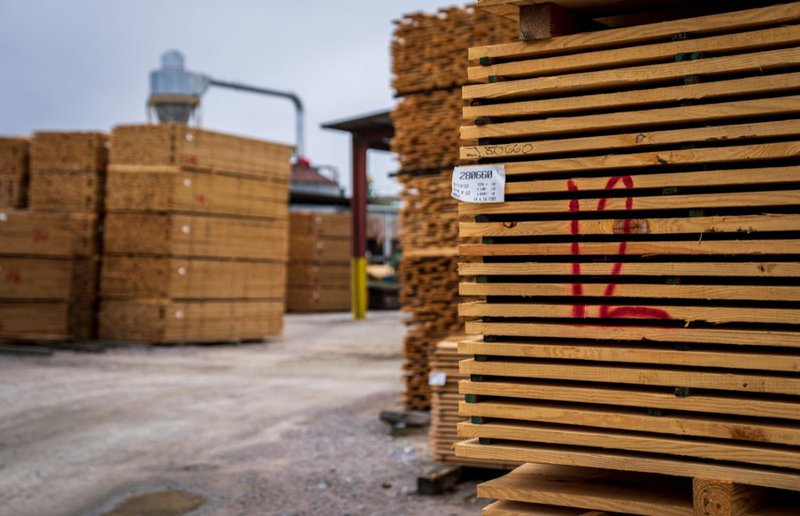 photo of stacked lumbers, ready for lumber distribution services