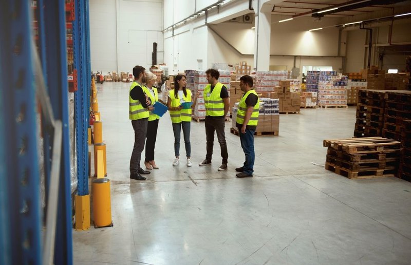 warehouse quality manager checking in on staff to ensure clear audit evidence
