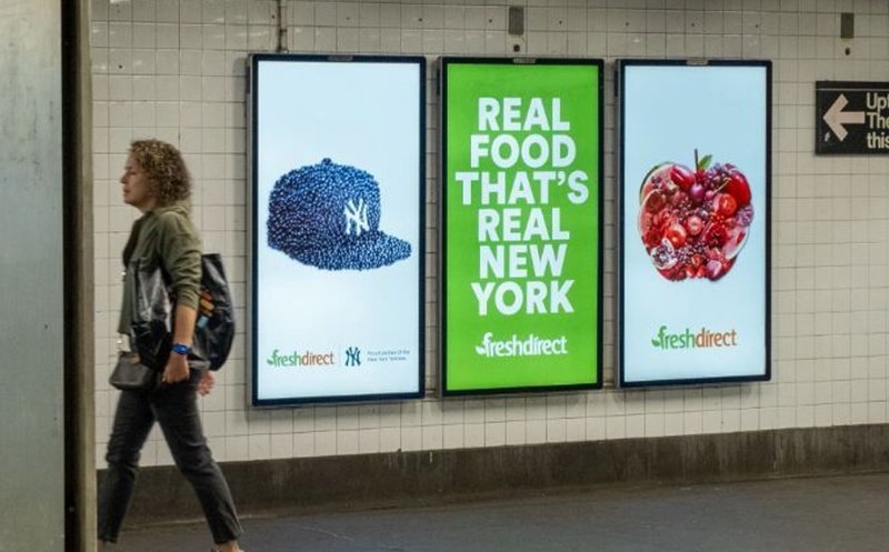 A street-level ads displayed in a subway station for close-range visibility.