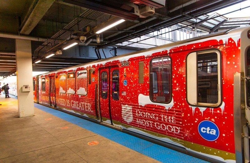 A transit advertising wrap displayed on a train at a station platform.