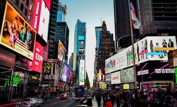 Digital billboards in a high-traffic city area showing billboard inventory access