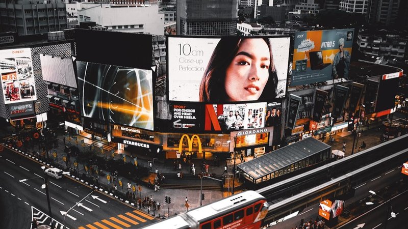 Many huge digital billboard at a busy intersection at night.Billboard Lighting Schedules 