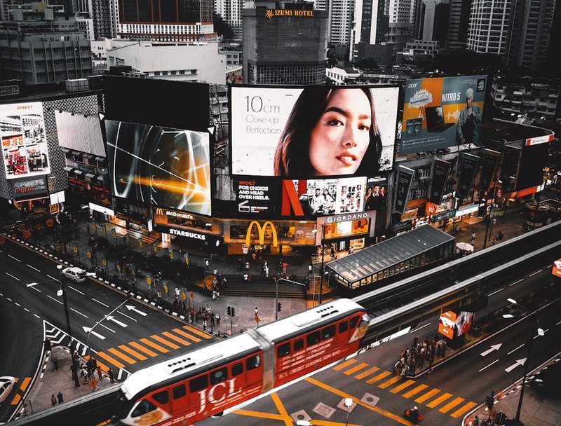 many billboards on the sides of buildings in a city