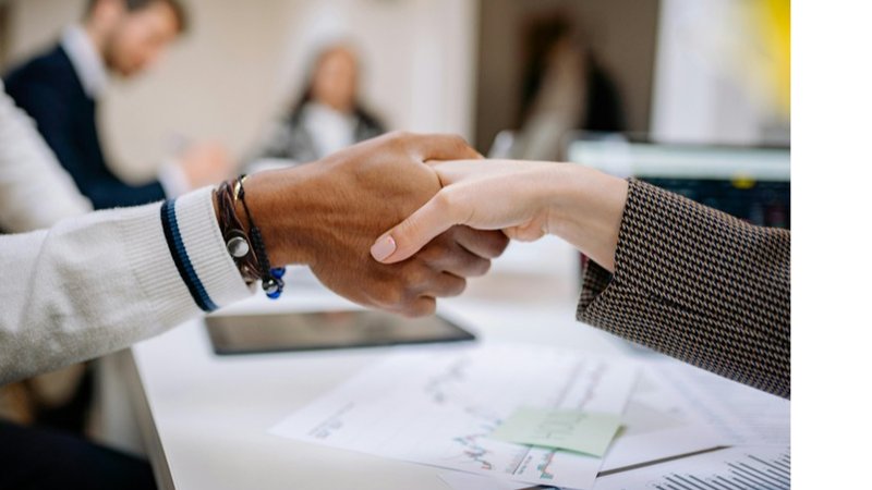 A handshake after working with an Atlanta billboard agency