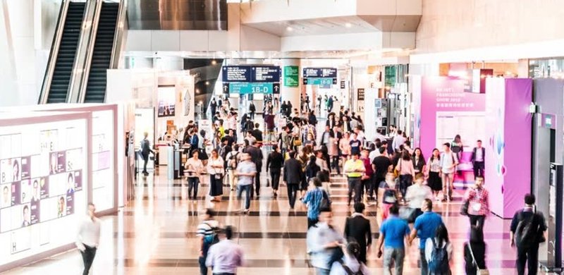 A busy mall corridor with digital displays showing how renting billboards reaches high-foot-traffic retail audiences.