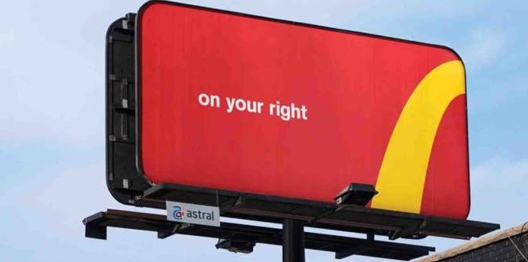A billboard ad using one clear message and strong brand colors to communicate instantly at road speed.