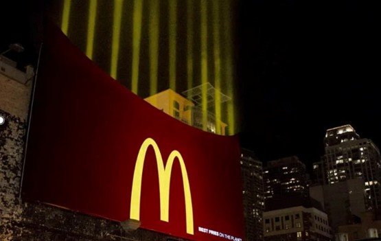 A large illuminated fastfood chain outdoor ad demonstrating billboard creative services