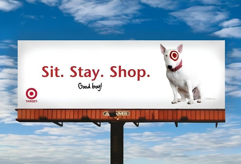 A Target billboard with dog image and text Sit. Stay. Shop promoting brand recognition.