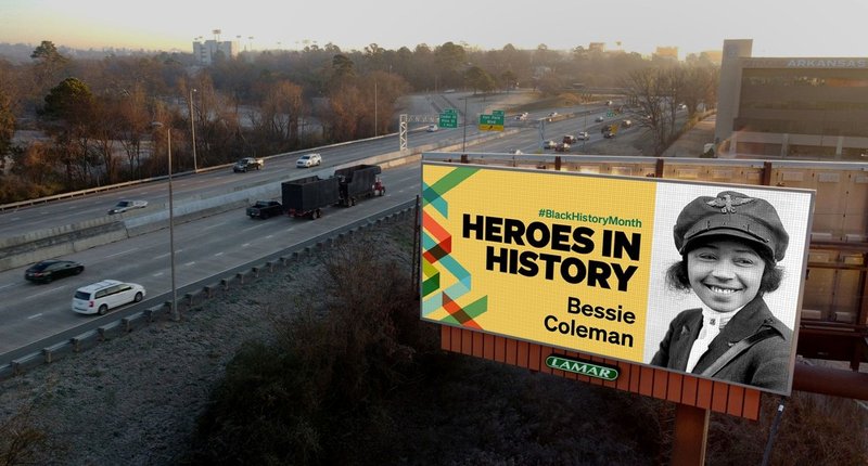 A billboard with text Heroes in history along the highway