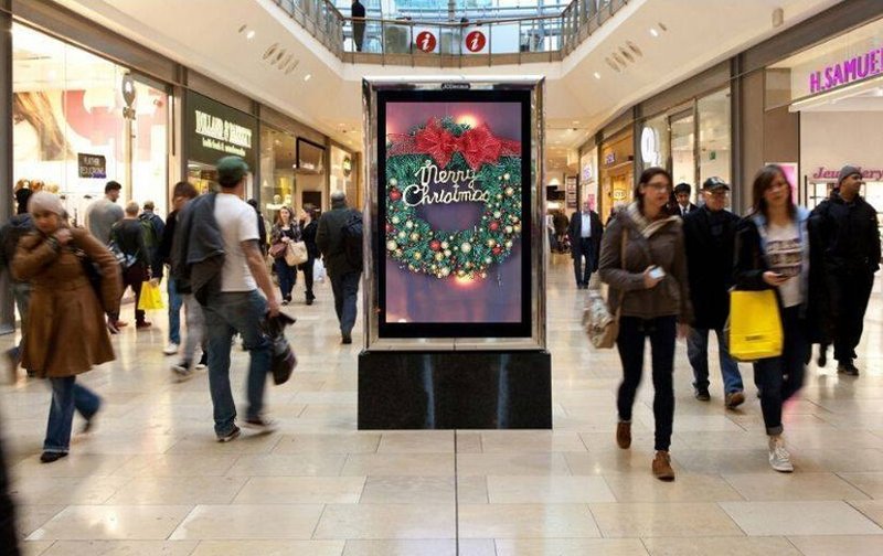 a Christmas billboard along the hallway of a mall