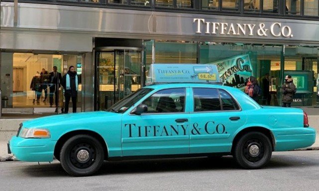 A Tiffany & Co. storefront with branded vehicle, illustrating premium visibility for billboards for luxury brands