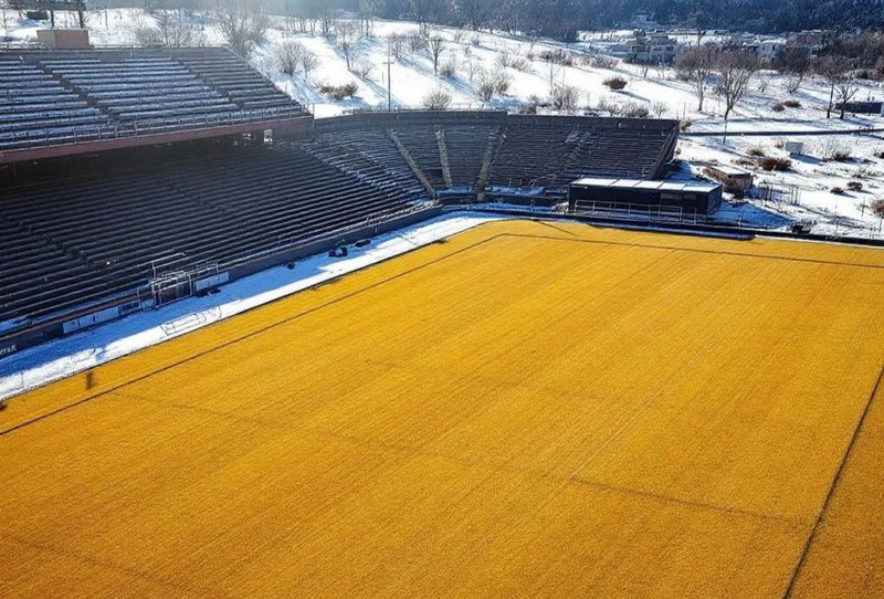 This shows an athletic field with brown turf during winter