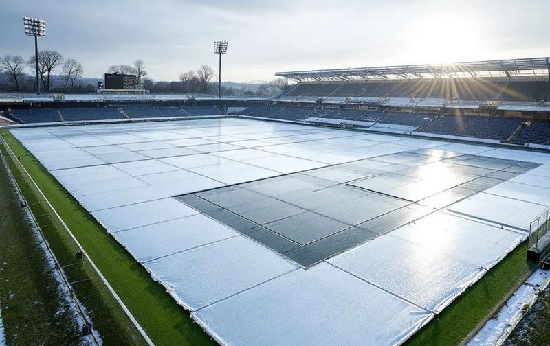 This photo shows an athletic field with a turf cover on it while growing grass in winter.