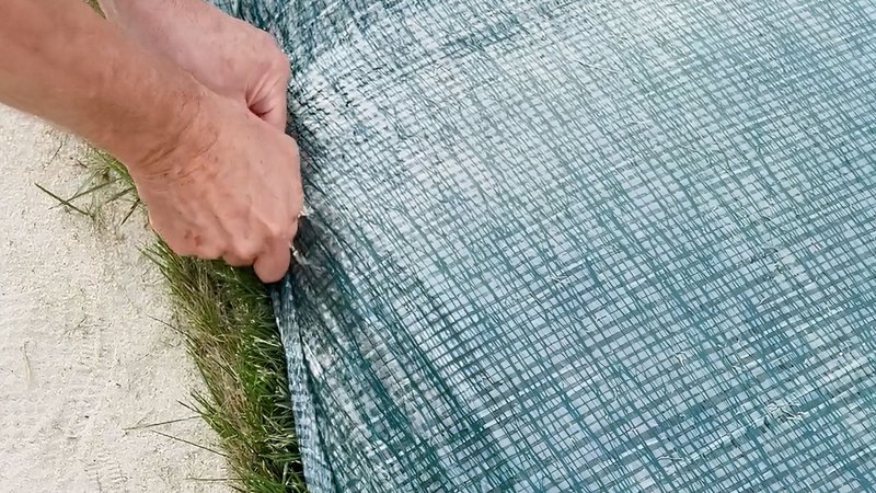 winter turf blankets being removed in the spring