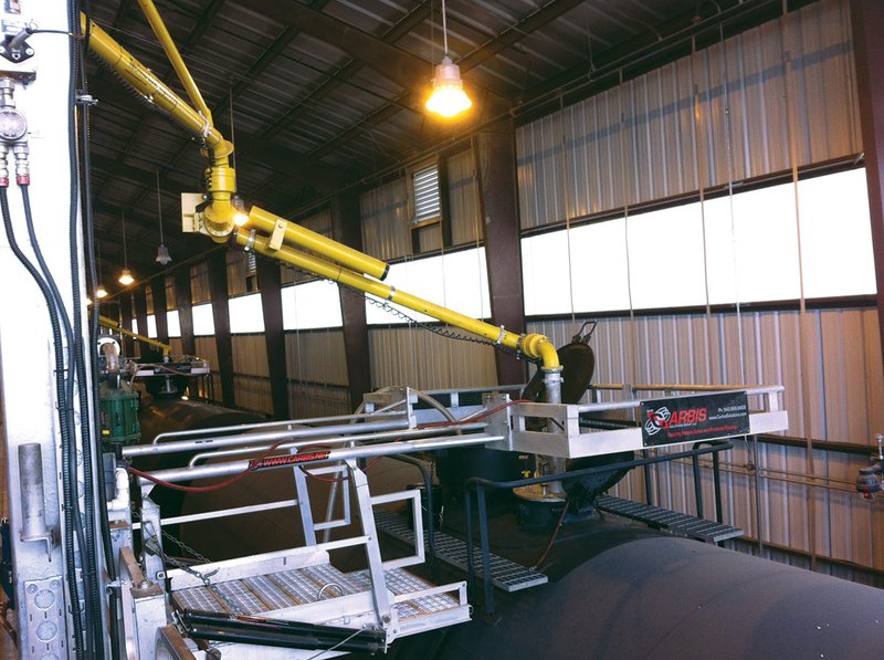 A top loading arm refilling fuel in a railcar