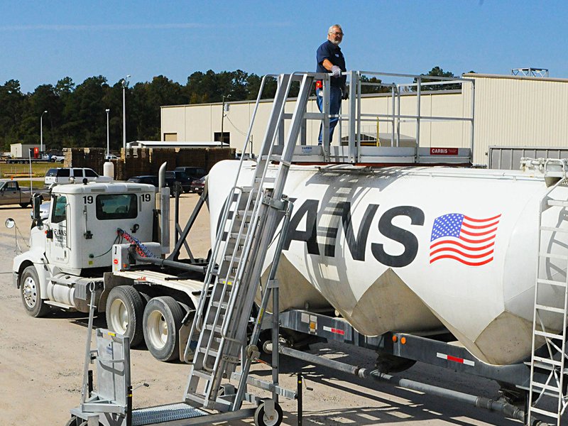 An image of a man who managed to climb on top of a truck using a portable access platform.