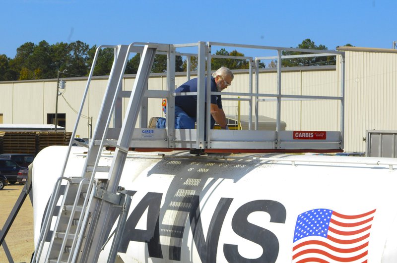 A portable access platform affixed to a tanker being used for loading