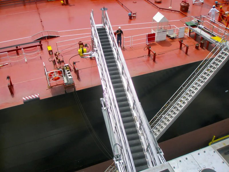 This photo features a ship gangway being lowered by highly trained crew members