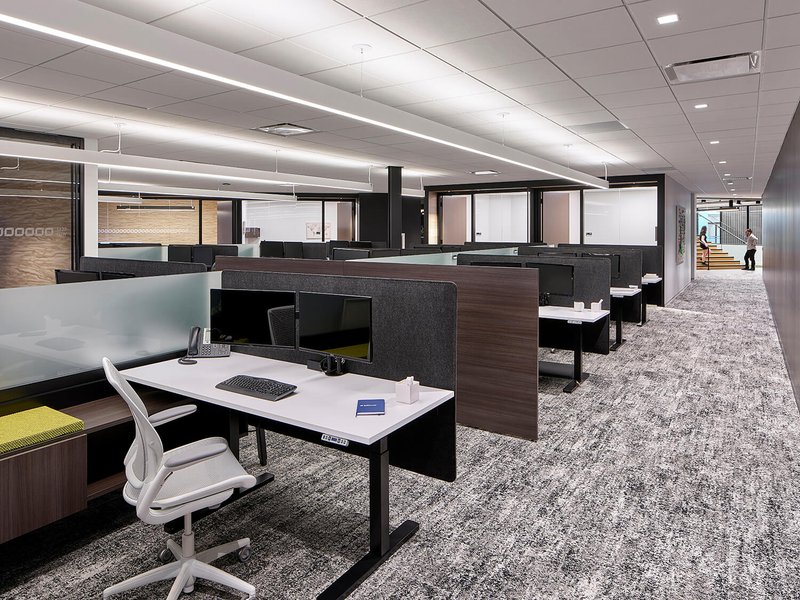 The image shows a commercial design from ICI in New Jersey. The image shows an office space with multiple workstations.