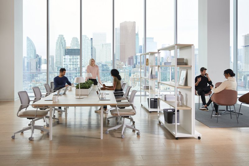 The image shows people working at an office. 